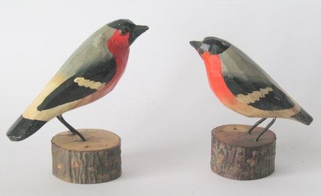 Pair of antique folk art bird carvings.