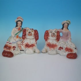 Pair Staffordshire Pottery recumbent spaniels with children