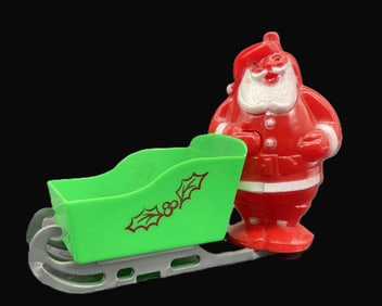 VINTAGE CHRISTMAS HARD PLASTIC - SANTA RIDES GREEN SLED CANDY CONTAINER