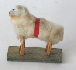 Antique German woolly sheep on platform toy.