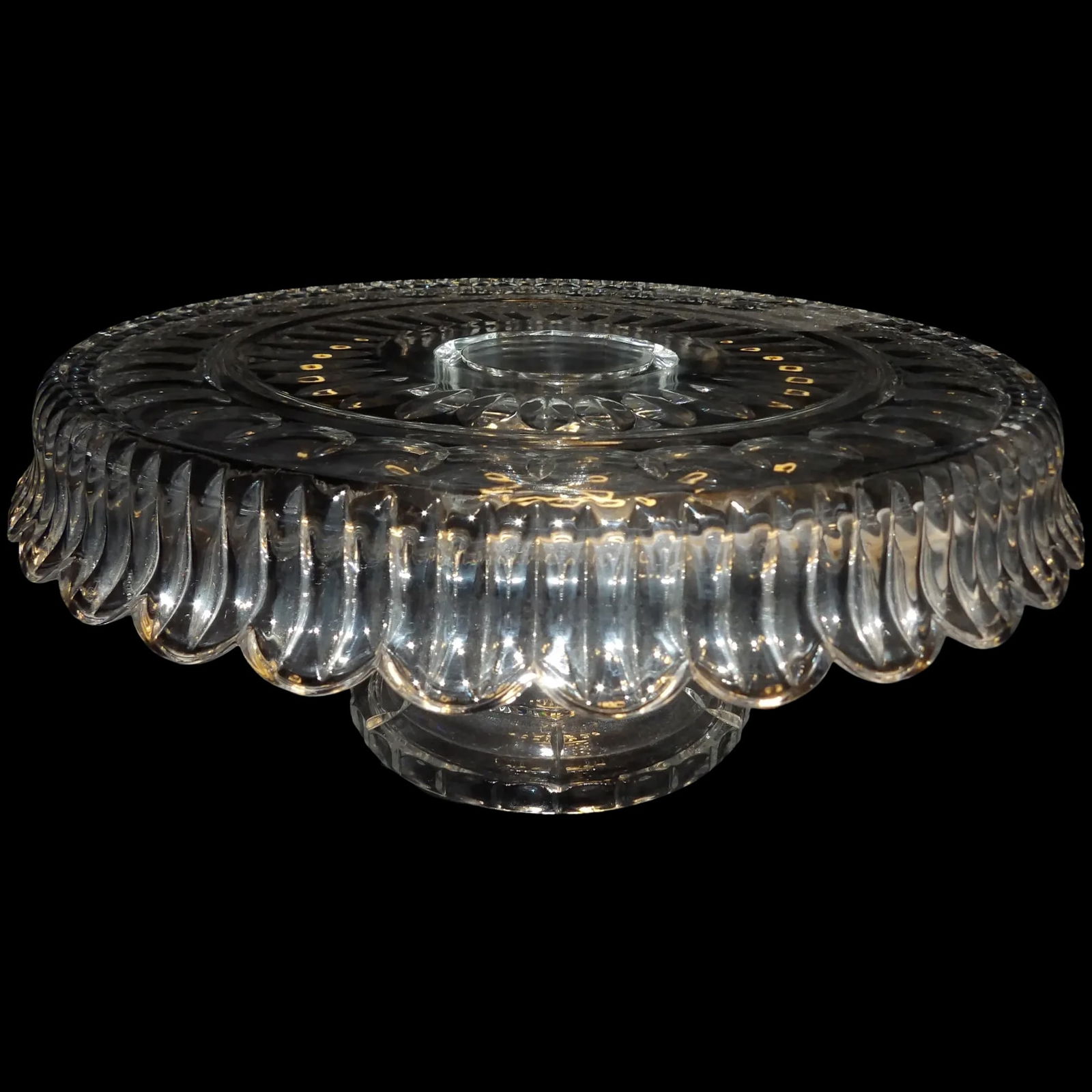 Crystal Thumbprint and Ray Cake Plate: This Crystal Thumbprint and Ray Cake Plate maker is unknown. It makes a striking presentation and rings like a bell when struck with the finger. The overriding glass flares out at the bottom and the p