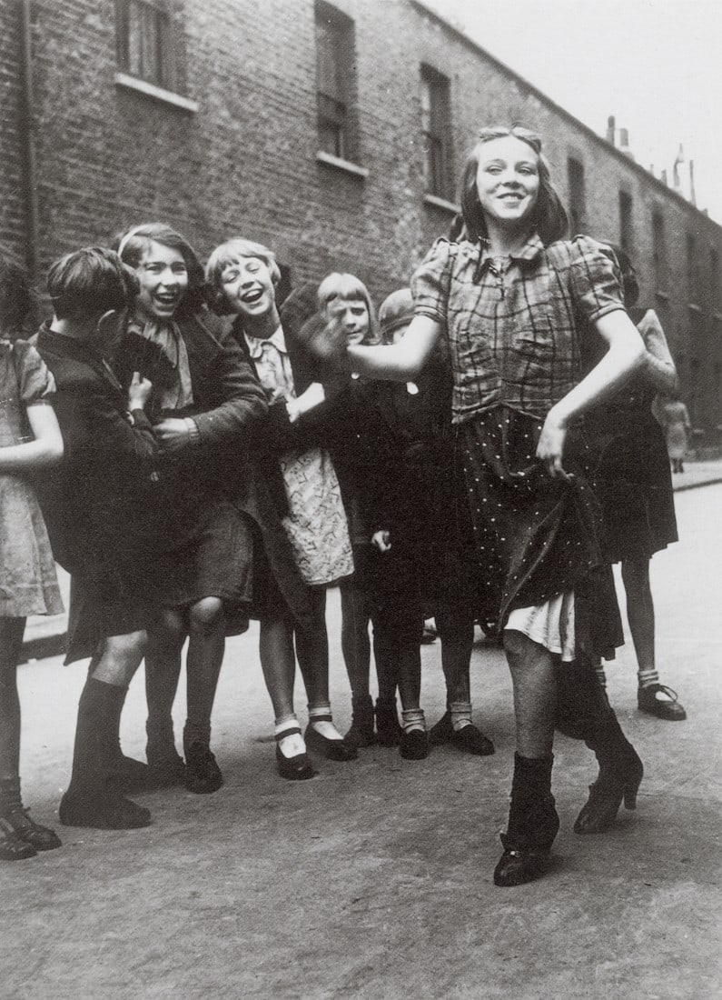 BILL BRANDT - The Lambeth Walk, 1936: Artist: Bill Brandt Title: The Lambeth Walk, 1936 Medium: Photo Litho, 1997, Italy Dimensions: 6.25x8.6" Description: Heat Wax Mounted on 8.5x11" Conservation Board Artist Bio: Bill Brandt (1904 ̵