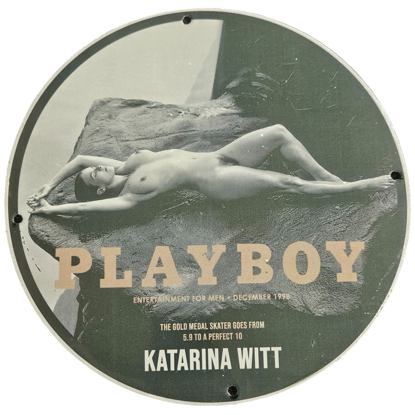 Vintage Playboy Porcelain Sign Featuring Katarina Witt - December 1998 Issue: This stunning vintage porcelain sign, originally featured in the December 1998 issue of Playboy, showcases the iconic figure of Olympic gold medalist Katarina Witt. Known for her grace and athleticism