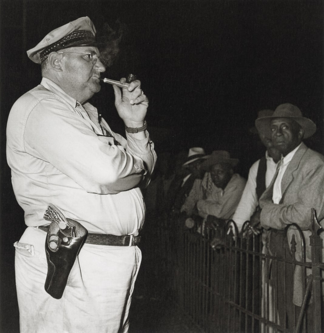 SAM SHAW - Sheriff at Voting Registration Site, 1946: Artist: Sam Shaw Title: Sheriff at a Voting Registration Site, Mississippi, 1946 Medium: Photo Litho, 2010, Germany Dimensions: 7.5x7.75" Description: Heat Wax Mounted on 8.5x11" Conservation Board Ar