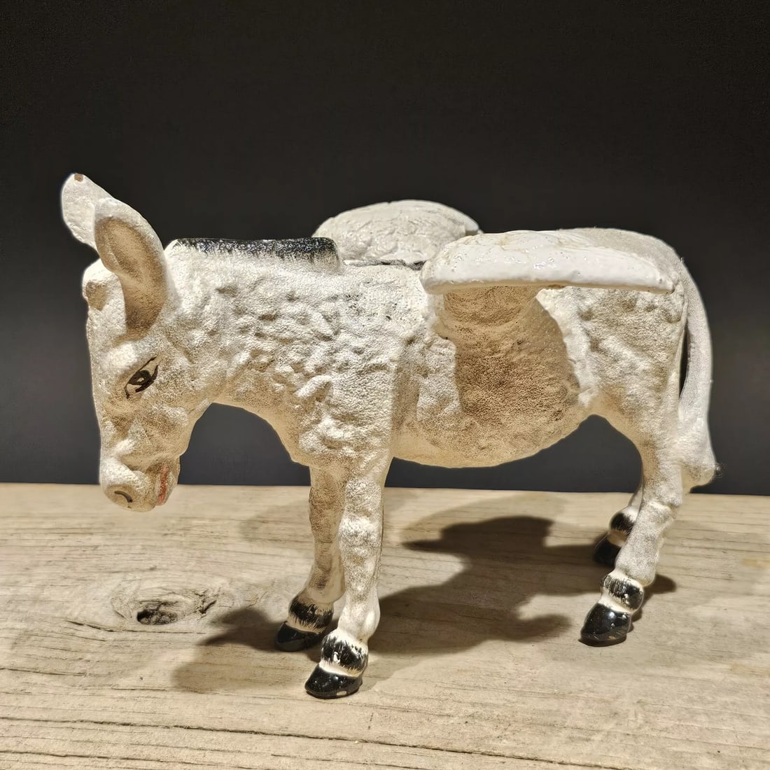 Cast Iron Flying Donkey Coin Bank: 7" Long x 5 1/4" Tall 4 1/5" Wide Great reproduction folk art cast iron mechanical coin bank. This piece was made to look just like an antique, but is actually new. Great realistic hand painted and di
