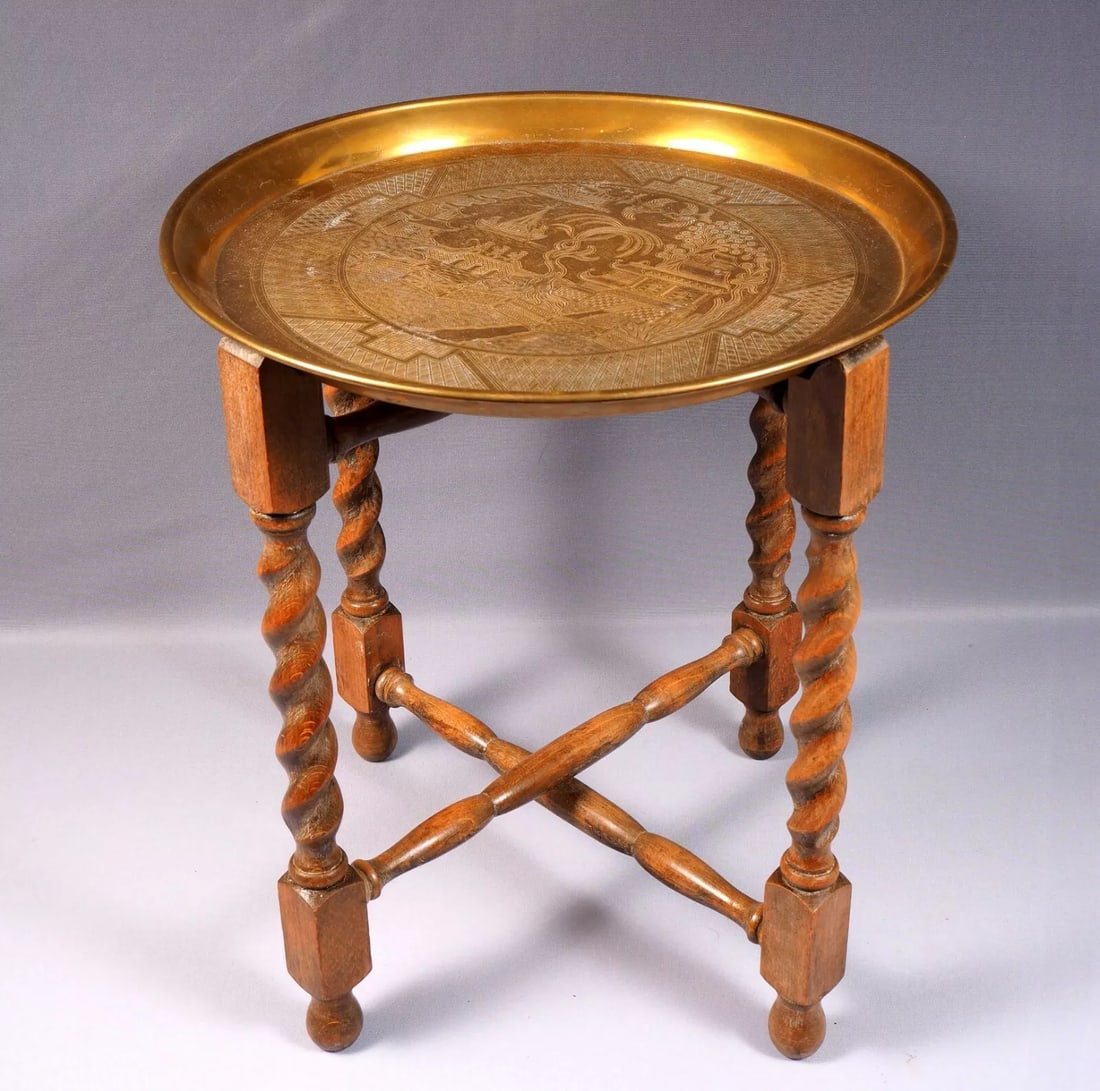 Folding Anglo-Indian Wine Coffee TABLE Brass Top Wood Legs Vintage: This quality example of the classic late 19th early 20th century Indian Brass table on a folding wood base. The table is in very good antique order. It has pleasing oriental landscape with pagodas on