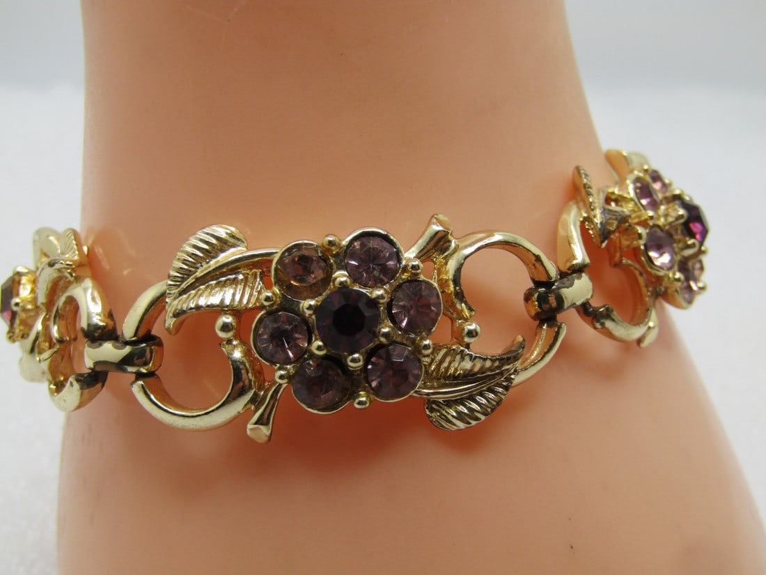 Vintage Purple Lavender Rhinestone Floral Bracelet, Signed Coro, 7", 1960's: Vintage Purple Lavender Rhinestone Floral Bracelet, Signed Coro, 7", 1960's. There are five floral links with two leaves each. The bracelet is appx. 3/4" wide with flip clasp where it is signed Coro.