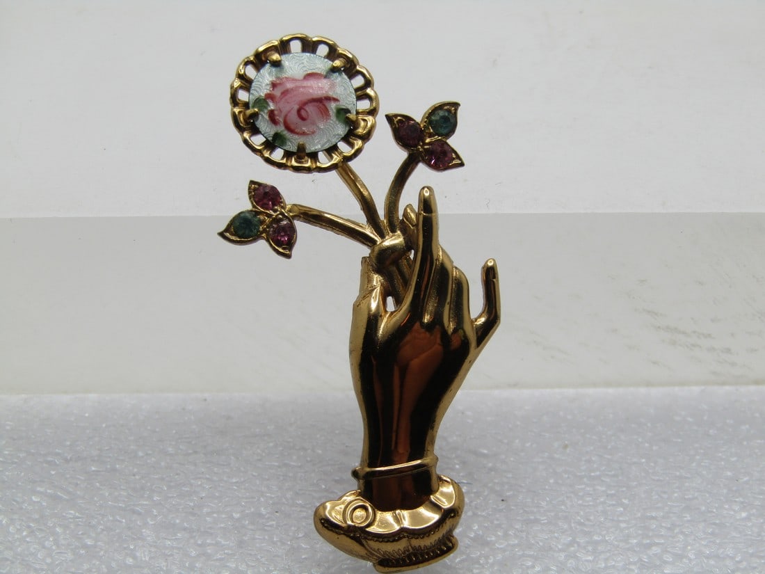 Vintage Guilloche Rose Hand Brooch, Rhinestones, 1960's, Coro: Vintage Guilloche Rose Hand Brooch, Rhinestones, 1960's, Coro. The hand is pointing upward holding a stem with the lower to stems having pink and blue rhinestones setin leaves and the larger - a round