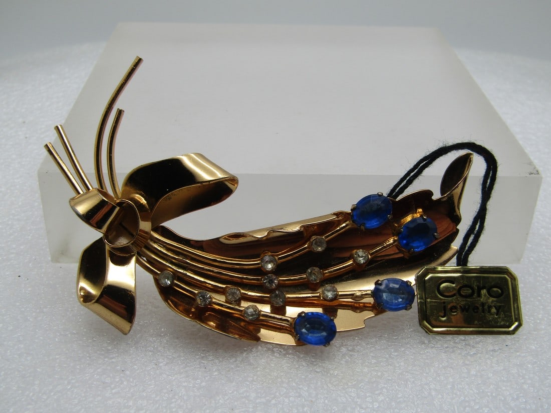 Vintage Coro Pegasus Rhinestone Brooch, With Tags, Leaf, Blue/Clear, 1950's-1960's: Vintage Coro Pegasus Rhinestone Brooch, With Tags, Leaf, Blue/Clear, 1950's-1960's. Thsi is a curved leaf with bow that has four stems of clear and blue rhinestones in the center of the leaf. Gold ton