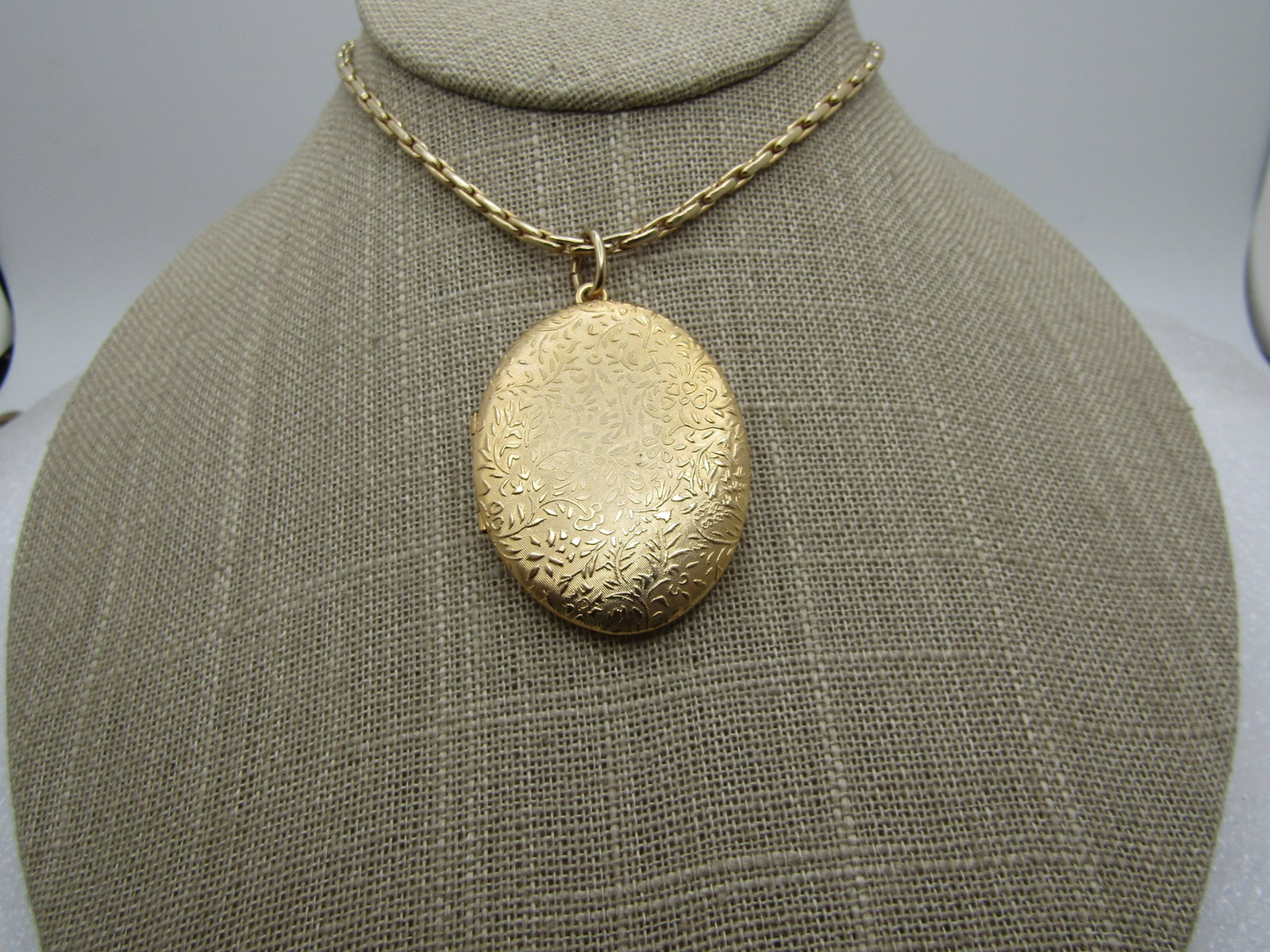 Vintage Floral Locket Necklace, 22" - 1960's-1970's,: Vintage Floral Locket Necklace, 22" - 1960's-1970's, gold tone with a design on the face and back of fines with leaves and floral accents with some petals looking like little hearts. It is appx. 2" ta