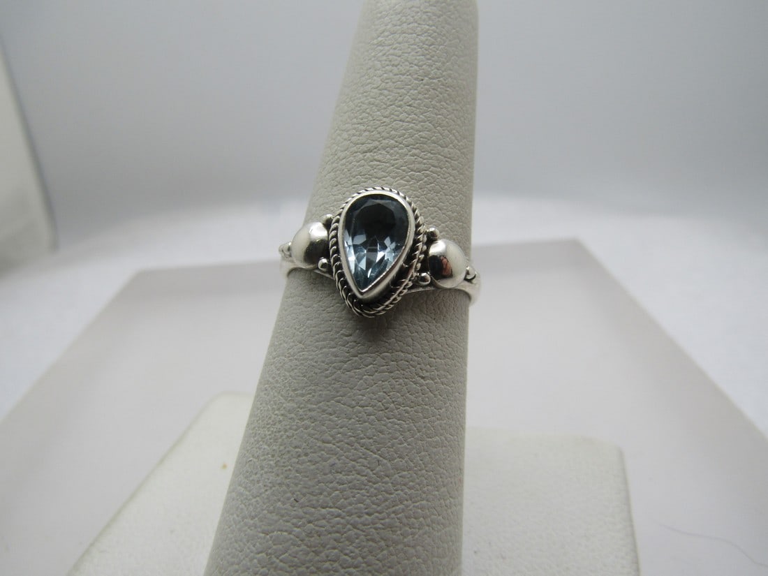 Vintage Blue Topaz Ring, Sz. 7, Bali/Southwestern/Boho Vibe: Vintage Blue Topaz Ring, Sz. 7, Bali/Southwestern/Boho Vibe. This has a pear-shaped blue topaz stone that is iappx. 8mm by 5.5mm that is bezel-set and set raised on the center of the ring with a wider