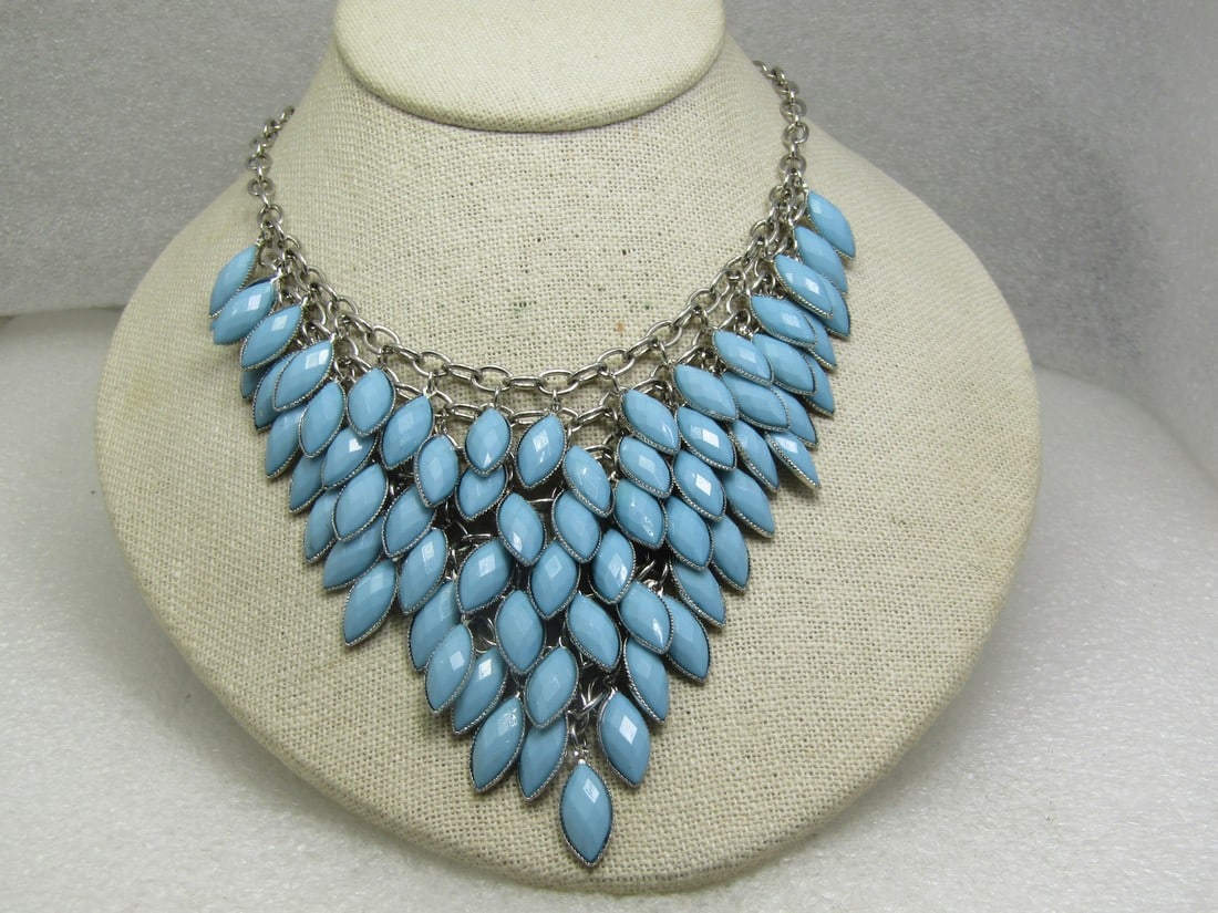 Faux Turquoise Bib Necklace, Marquise, 19", Mod Southwestern Vibe: Faux Turquoise Bib Necklace, Marquise, 19", Silver Tone with lobster clasp. Mod Southwestern Vibe This has a drop of honeycomb faceted faux turquoise lucite marquise cabochons that are set with a beze