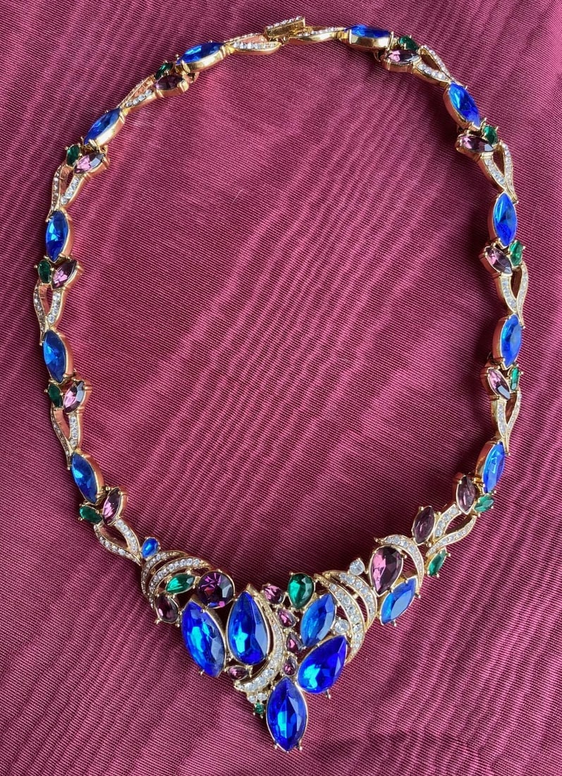 Vintage 1980s Trifari Rhinestone Necklace Fruit Salad Glam 22 Inches: Vintage from the 1980s Materials: Glass Style: Mid-century Necklace length: 22 Inches Rhinestones Fruit salad of colors, in predominate blues Marcasite links Goldtone Substantial statement pendant - 1