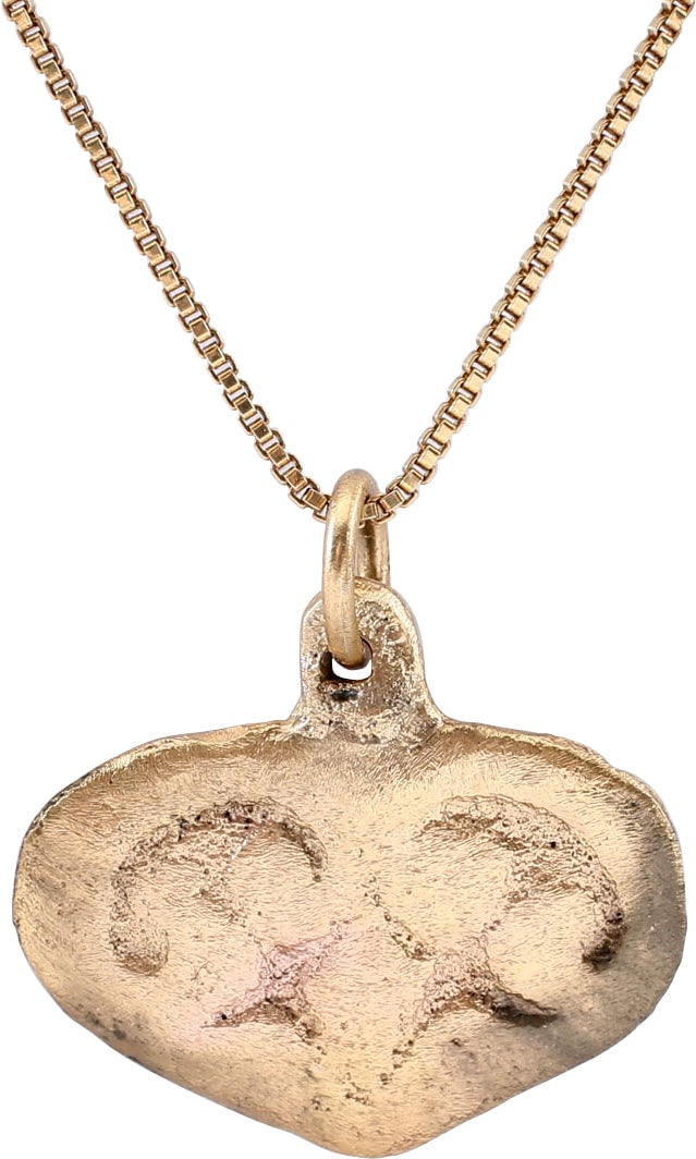 FINE VIKING HEART PENDANT, 9TH-10TH CENTURY AD.: Gilt bronze. Just over 3/4" total height (0.755" )" with broad raised edge defining the cusped top heart. The field with a trefoil with scrolls to the side leaves. Surface textured from burial. Profes