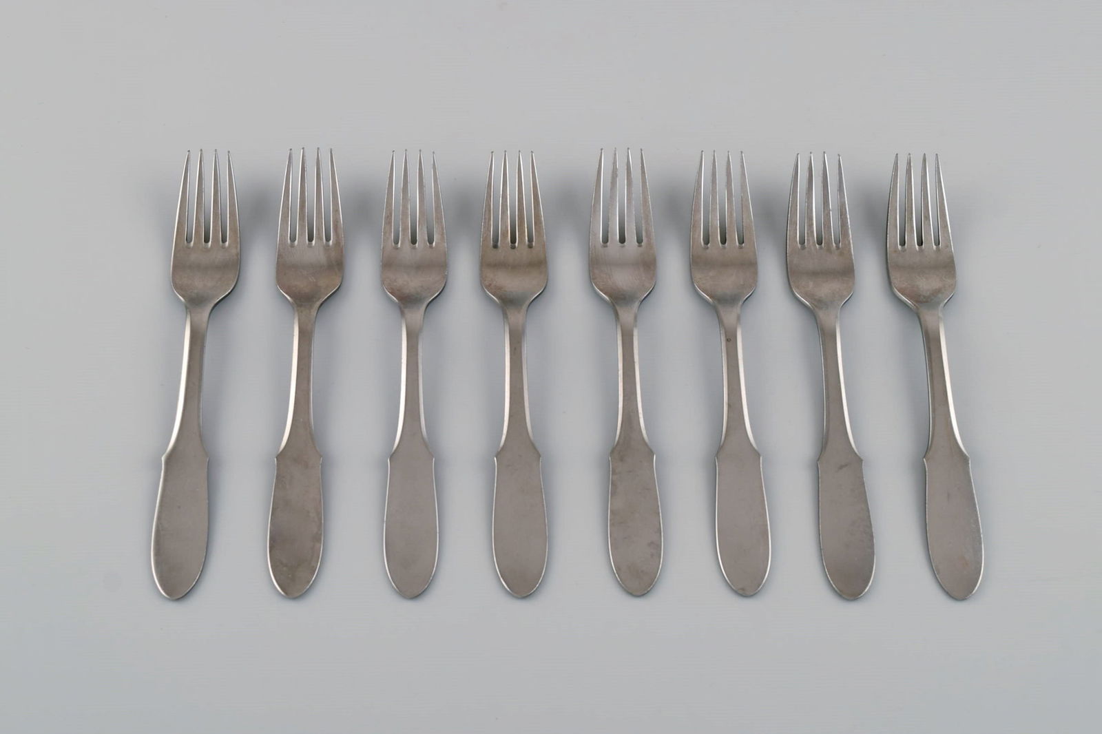 Gundorph Albertus for Georg Jensen. Eight Mitra forks in stainless steel. 1970s.: Title: Gundorph Albertus for Georg Jensen. Eight Mitra forks in stainless steel. 1970s. Description: Gundorph Albertus for Georg Jensen. Eight Mitra forks in stainless steel. 1970s. Length: 15 cm. In