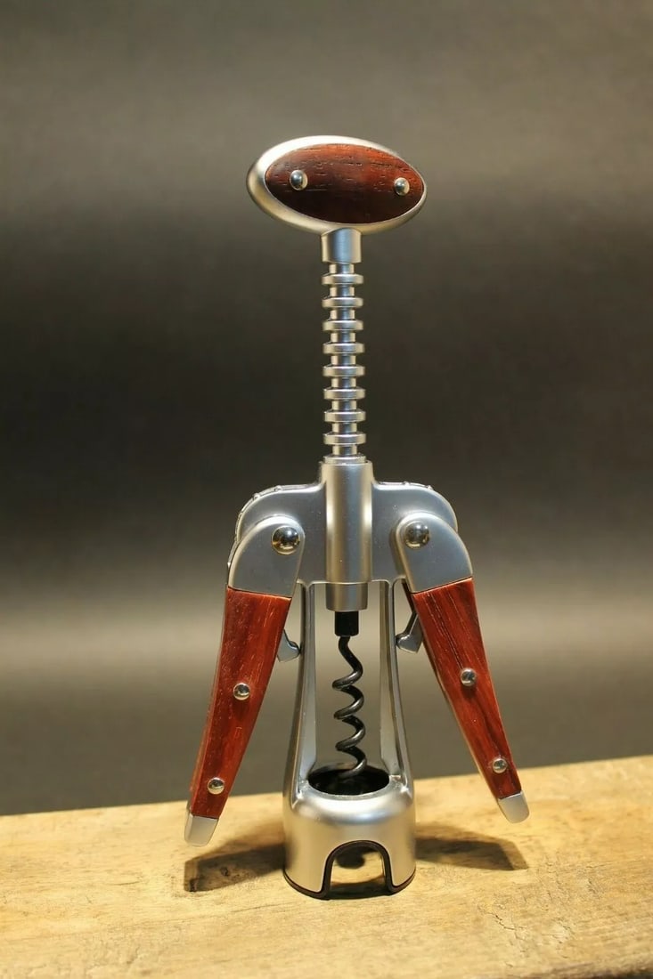 Laguiole Corkscrew with wood Handles: 7 1/2" Tall 3" Wide Nice quality heavy wing style Laguiole corkscrew! The heavy weight corkscrew (15.2 oz.) has wood inlaid handles. Open spiral with non-stick black surface on spiral. Reserve: $30.00