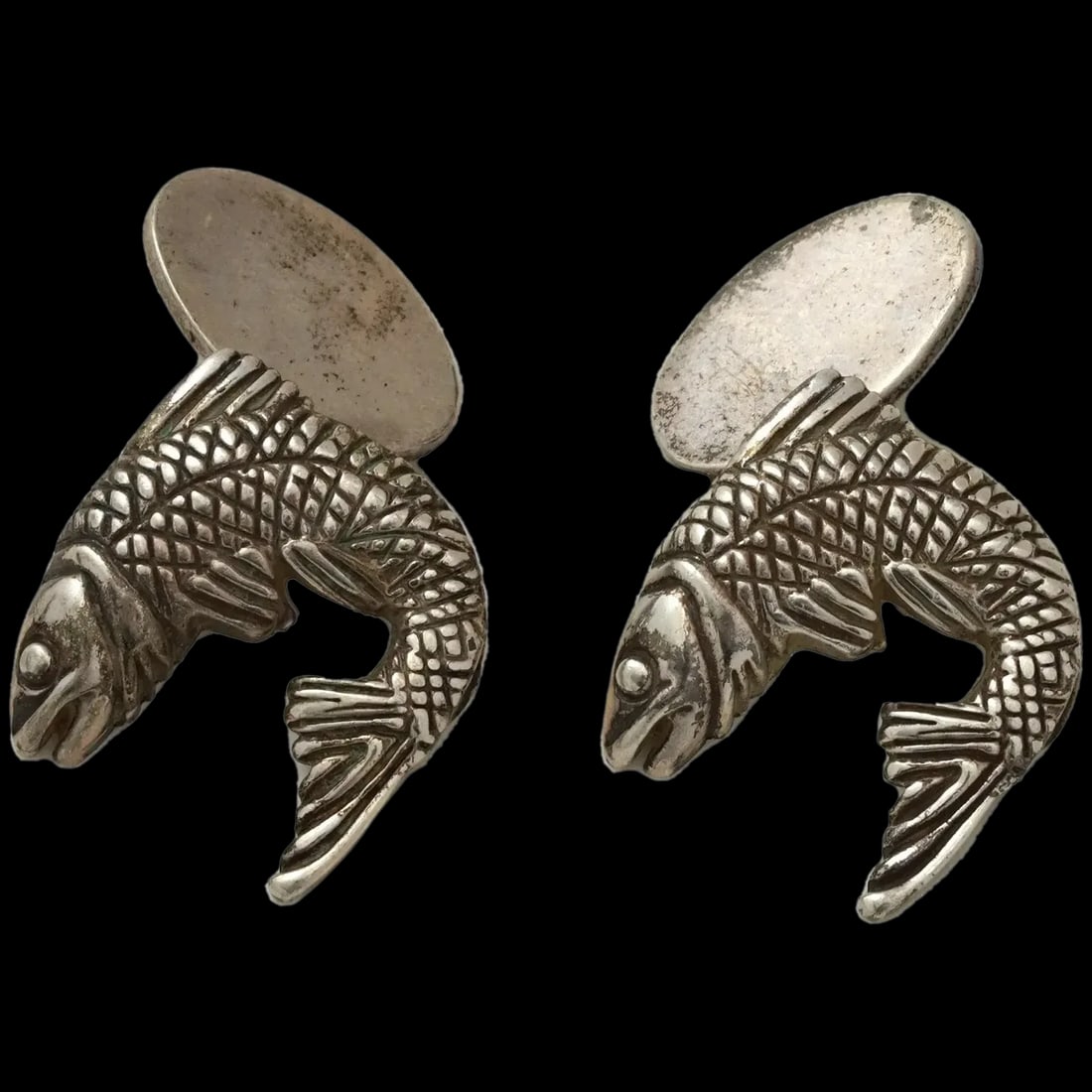Attr To Webster Sterling Silver Fish Form Cufflinks: A pair of Sterling Silver figural cufflinks, attributed to Stephen Webster. the cufflinks are made in the shape of fish, engraved with detailed patterns. Marked with a Sterling Silver standard hallmar