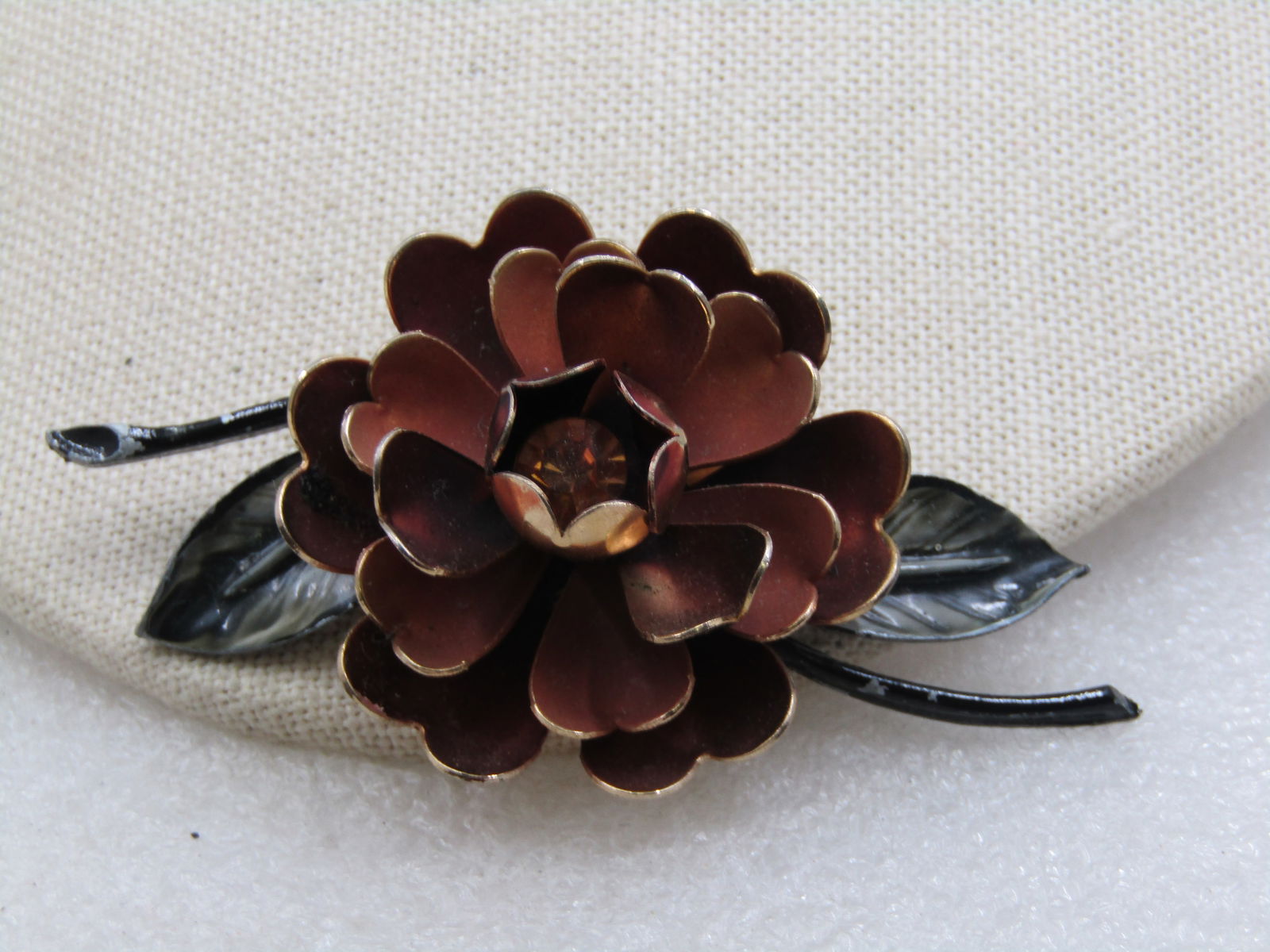 Vintage Coro Enameled Floral Brooch with Rhinestone, 3", 1940's: Vintage Coro Enameled Floral Brooch with Rhinestone, 3", 1940's. This is 3" wide and apx. 1.5" tall with a tiered brown enameled flower with a center orange rhienstone and dark green leaves, one on ea