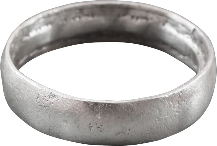 VIKING WOMAN’S WEDDING RING SIZE 4: Cambridgeshire, England, 9th-11th century AD. Silvered bronze, size 4. 3.8mm width band with low rounded face. Made with a core filling the inside which distributed the flowing metal and allowed for s