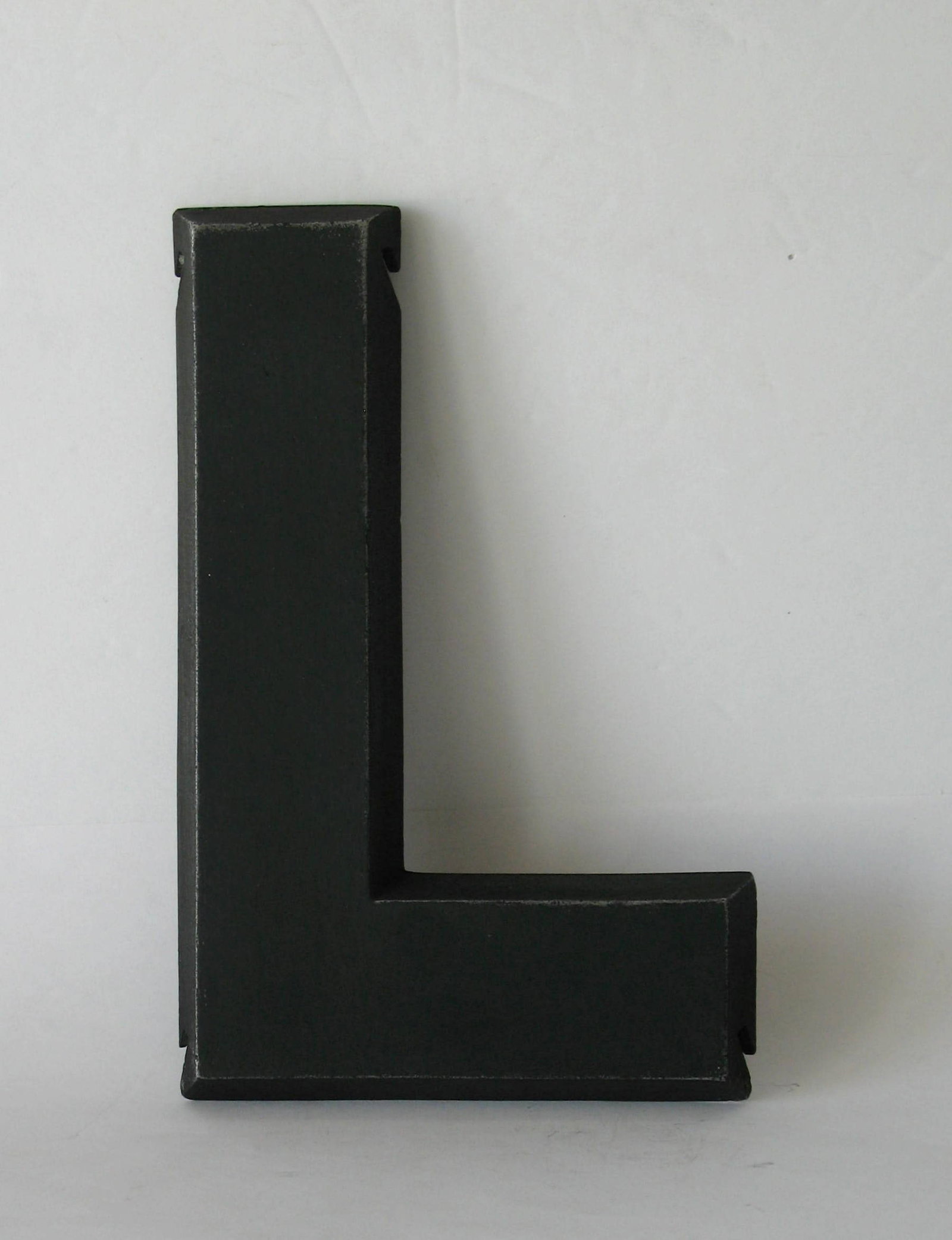 Vintage cast metal letter “L:.: Title: Vintage cast metal letter “L:. Date/Period: 1950's Dimension: 8” high Additional Information: Nice vintage cast metal letter “L” from an old advertising sign in great al