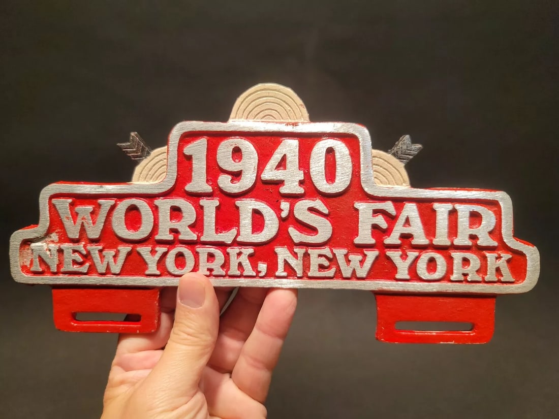 1940 World's Fair New York License Plate Frame Topper: 10 1/2"Wide x 5" High Such a neat accurate reproduction aluminum license plate frame. This frame is all solid metal, hand painted. I checked it with a magnet it doesn't attract. Reserve: $25.00 Shippi