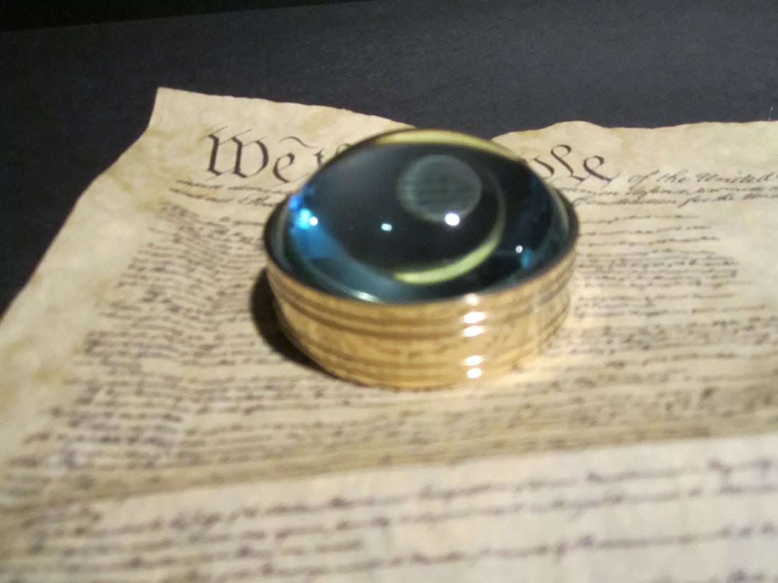 Small Round Brass Heavy Magnifying Glass Desktop Lens: Vintage Antique Style Solid Brass Heavy Glass Magnifying Desktop Lens Description 2" 1/8" Wide x 1 1/8" High Nice reproduction of an antique magnifying lens. Nice heavy quality thick glass. This piece