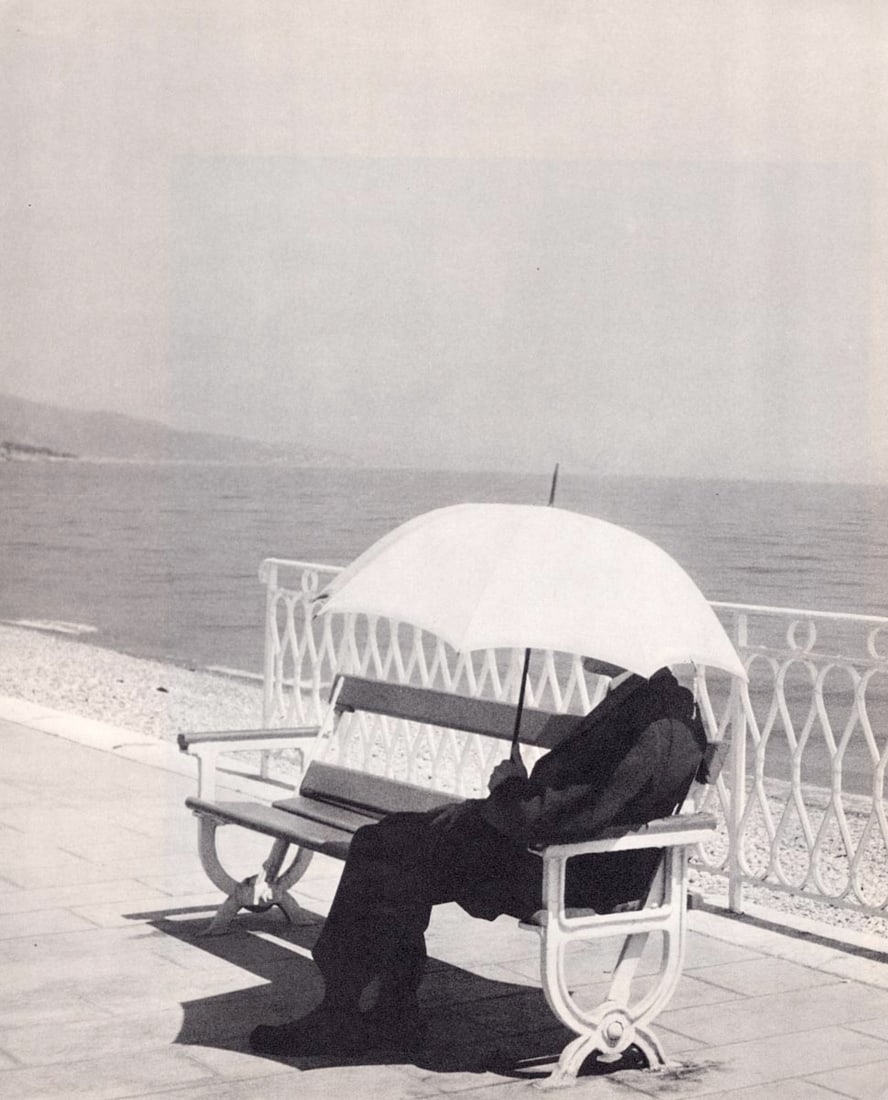 BRASSAI - L'homme a l'ombrelle, Menton, 1930: Artist: BRASSAI Print Title: L'homme a l'ombrelle, Menton, 1930 Medium: Sheet-fed Gravure Printing Date: 1960's Printed in Switzerland Image size approx. 10.5 x 9 inches Brassai, pseudonym of Gyula Ha