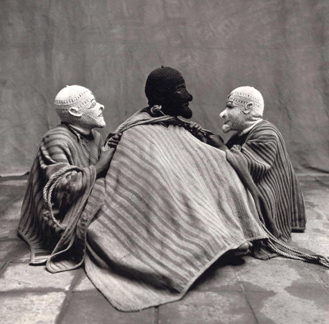 IRVING PENN - Three Sitting Men in Masks, Cuzco, 1948: Artist: IRVING PENN Print Title: Three Sitting Men in Masks, Cuzco, 1948 Medium: Quad-tone Photoengraving Printed 1990’s in the US Image size (inches) approx. 7 x 7” Irving Penn was an Ame