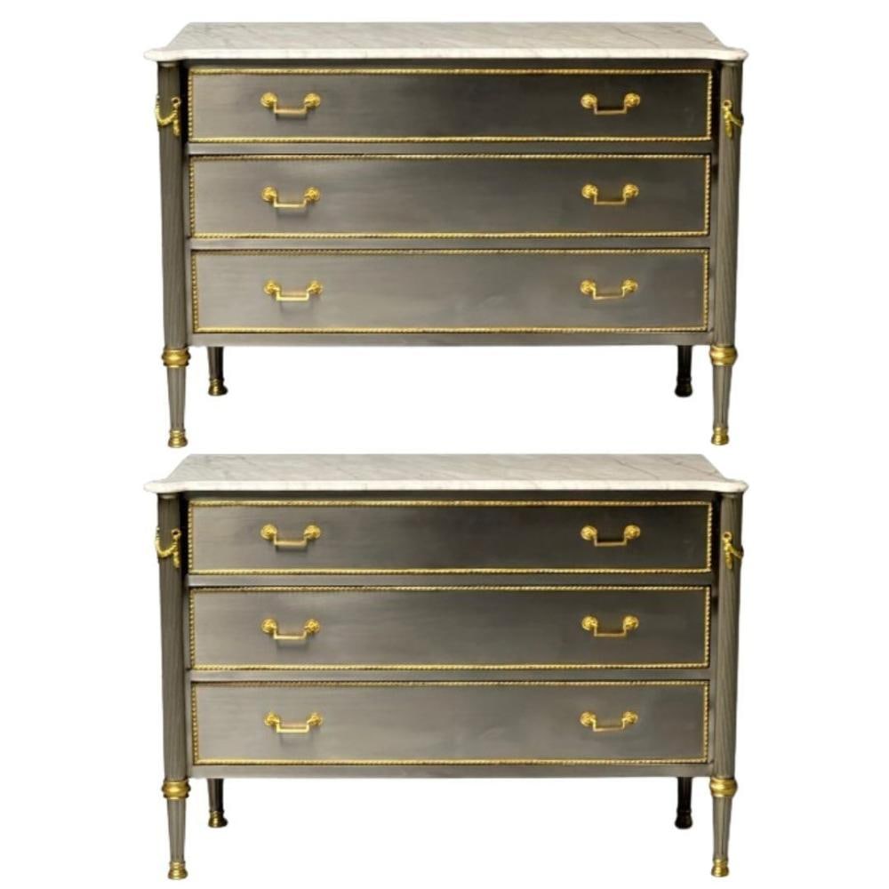 John Vesey Style, Louis XVI, Hollywood Regency, Commodes, Steel, Marble, Bronze: John Vesey Style, Louis XVI, Pair of Commodes, Steel, Marble, Bronze Three drawer bronze mounted steel veneered commodes. Each supporting a white and gray veined marble top, the case of wood form full