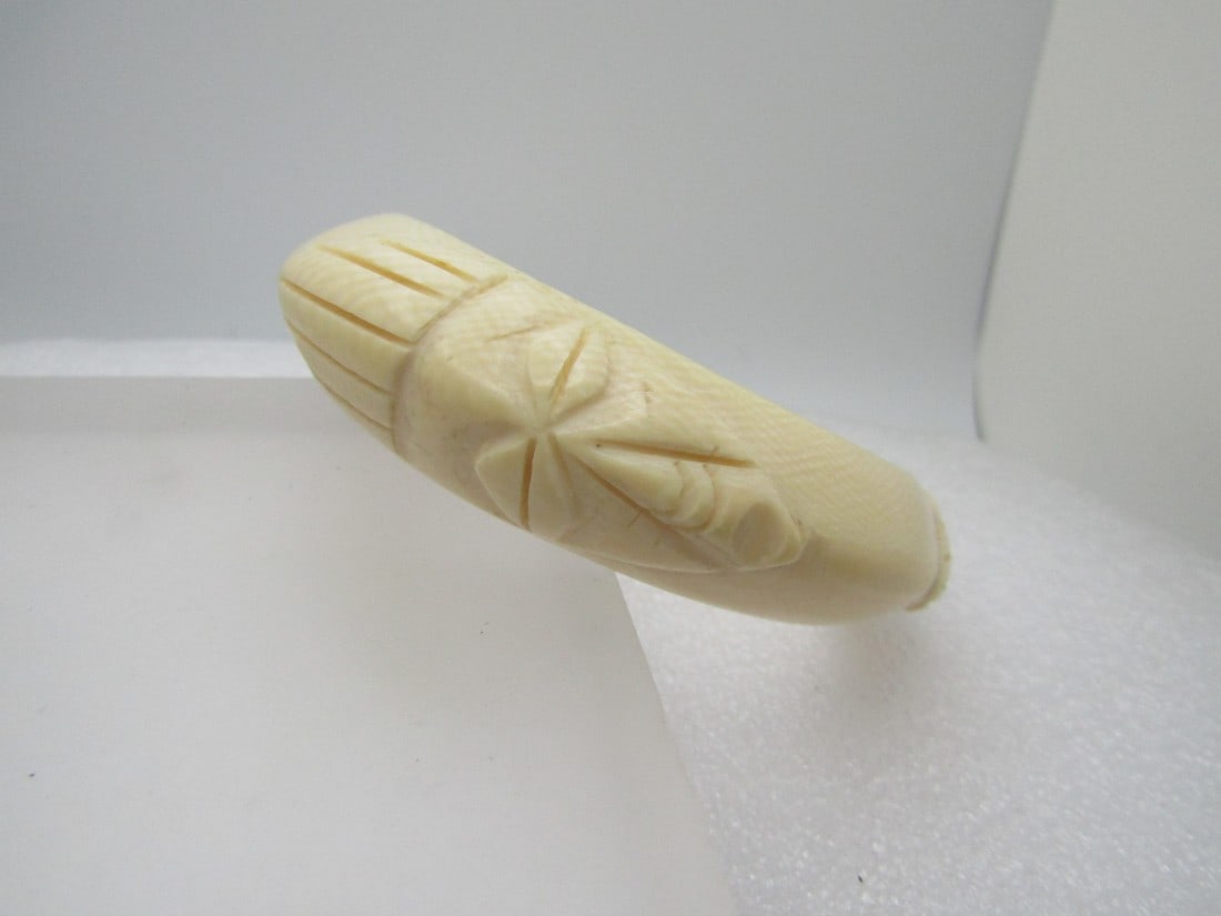 Vintage White Tribal Bracelet, Carved White/Ivory Plastic or Bone.\, 8", 1970's-1990's: Vintage White Tribal Bracelet, Carved White/Ivory Plastic or Bone, 8", 1970's-1990's. This is appx. 3/4" wide. It is domed with three tribal faces carved into the bracelet. Unisex. The opening is an o