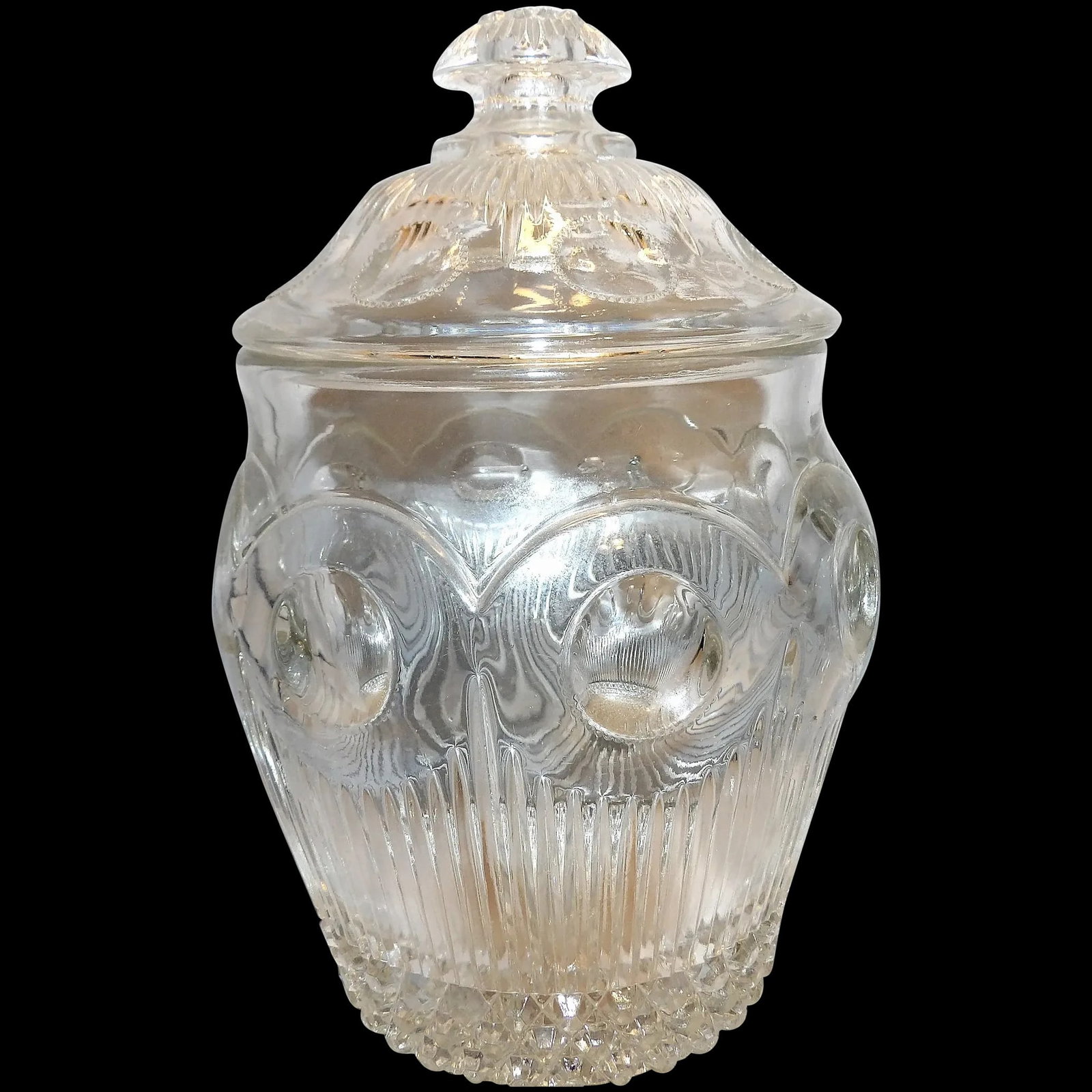 No. 15078 MANHATTAN Cookie Jar by United States Glass Company (Pittsburgh-PA, Company Operated:: The Manhattan pattern was one of the more popular patterns produced by United States Glass Co. This pattern was introduced in 1902- reissued in 1940 as bulls eye. The Scalloped rim has additional "bum