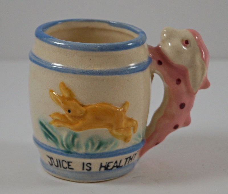 Children’s Ceramic Juice Is Healthy Mug Rabbit: Title: Children’s Ceramic Juice Is Healthy Mug Rabbit Dimension: 2 5/8” tall x app. 2” diameter at top. Date: Unknown Additional Information: Offering a wonderful child’s ceram