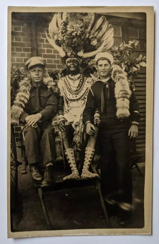 BIZARRE REAL PHOTO POSTCARD MILITARY MEN POSE w NATIVE CHIEF w GIANT HEADRESS (1 of 2)