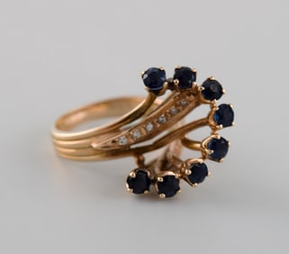 Swedish jeweler. Large vintage ring in 14 carat gold adorned with faceted sapphires and diamonds.