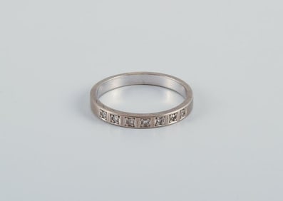 Scandinavian goldsmith. Classic alliance ring in white gold adorned with seven diamonds.