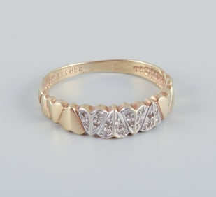 8 karat gold ring with numerous small diamonds in a modernist design.