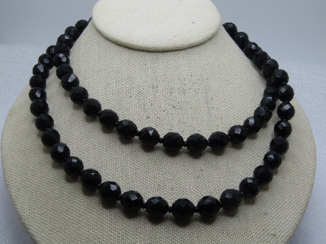 Vintage Black Glass Faceted Necklace, 34", 1940's-1950's: Vintage Black Glass Faceted Necklace, 34", 1940's-1950's. The beads are appx. 9.5mm with a black seed bead between each bead. spring clasp. Basic necklace that is a classic design that stands the test
