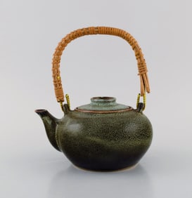 Chinese teapot in glazed stoneware with wicker handle. Beautiful speckled glaze in dark green and