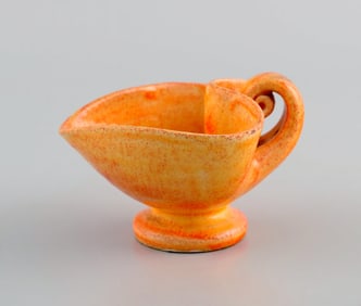 Kähler, Denmark. Cream jug in glazed stoneware. Beautiful orange uranium glaze. 1940s.
