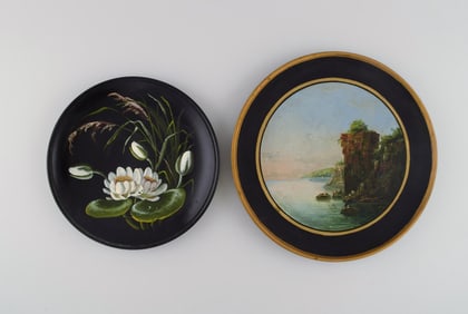 Two antique Hjorth decorative plates in hand-painted teracotta. Late 19th century.