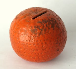 Antique red ware bank in the shape of an orange.