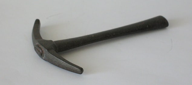 Vintage cast iron pick ax paper weight.