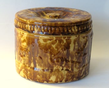 Antique butter crock with brown sponge decoration.