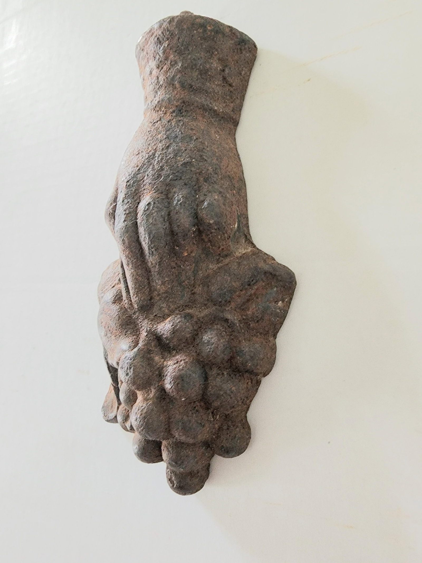 HOLDING A CLUSTER OF GRAPES: THIS IS A GATE WEIGHT OR CURTAIN WEIGHT. HOLDING A CLUSTER OF GRAPES. AN UNUSUAL FORM. BLY USED ON A GATE OF VINEYARD. IN ORIGINAL CONDITION. C.1800-20. 7 INCHES X 3.25 INCHES. IT HAS THE ORIGINAL IRO