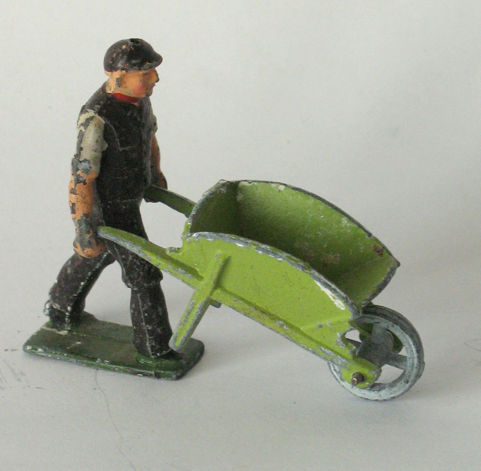 Antique cast metal toy man with his wheel barrow. (1 of 2)