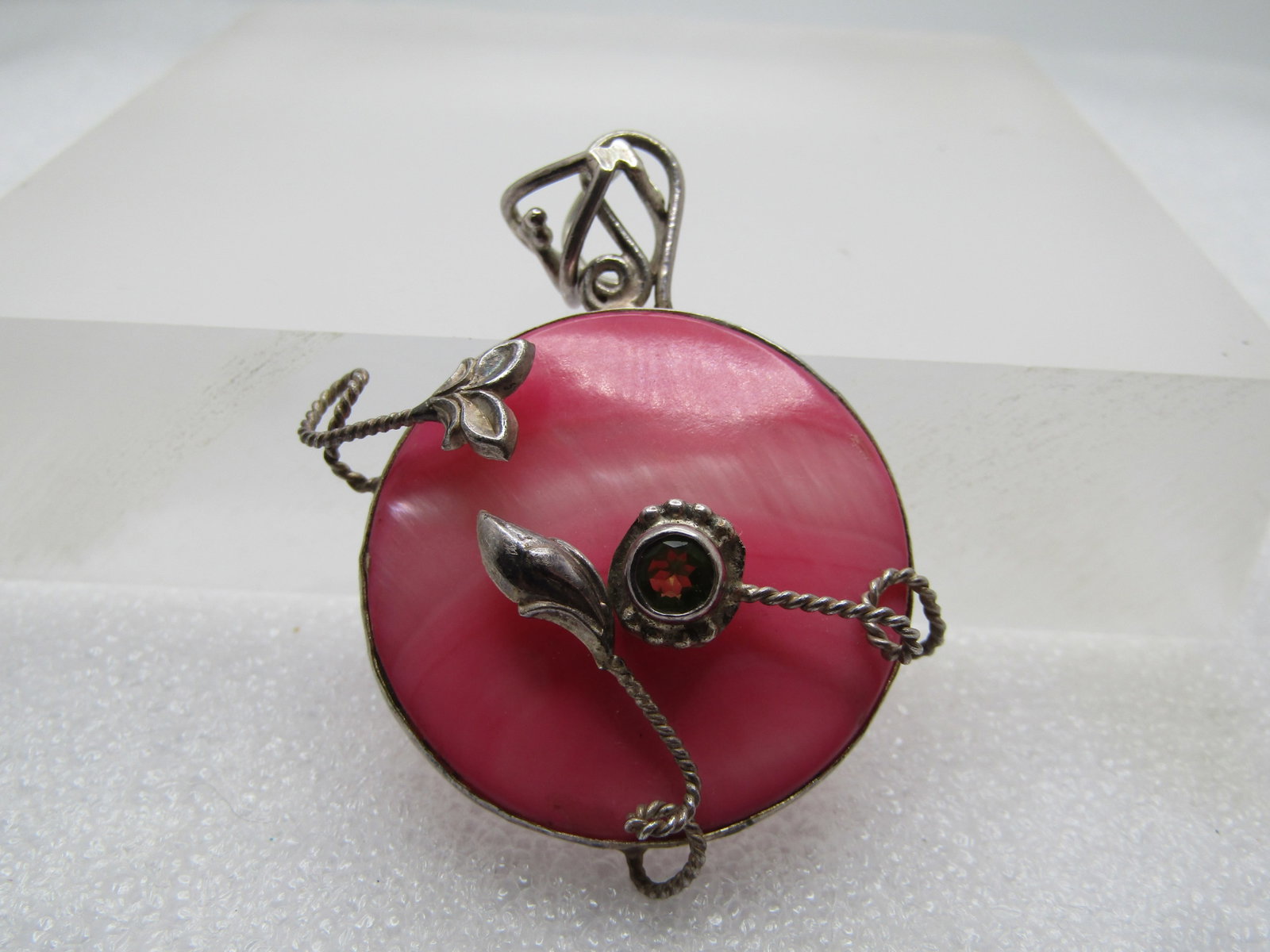 Vintage Sterling Pink MOP & Peridot Pendant, 1980's-1990's, Hand Crafted: Vintage Sterling Pink MOP & Peridot Pendant, 1980's-1990's, Hand Crafted. The mother-of-pearl is set in a bezel and is a vibrant dyed pink. It is appx. 1.25" and above that is a hook scrolled bail wit