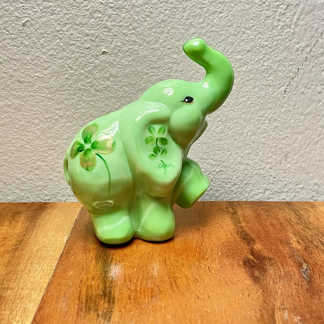 FENTON Foot Up Chameleon Green Elephant 4” Glass Figurine Signed J. Cutshaw: This FENTON glass figurine features a charming Elephant design in a vibrant Chameleon Green color. Measuring 3.5 inches in length, 4 inches in height, and 1.75 inches in width, the figurine is signed