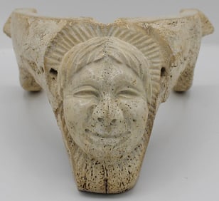A Carved Inuit Cribbage board with a Man's face
