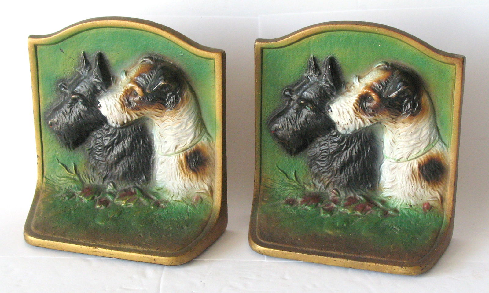 Antique cast iron Terrier book ends.: Title: Antique cast iron Terrier book ends. Date/Period: 1930's Dimension: 5 1/2” x 5 1/4” Additional Information: Antique cast iron Terrier bookends made by Hubley in great original paint