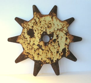 Antique metal farm equipment wheel.